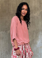 round neck pink top in silk crepe on top of knees long pant batik decorated by Bali artisan