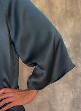 Load image into Gallery viewer, detail of a woman long sleeves top hand-made in silk satin color dark grey
