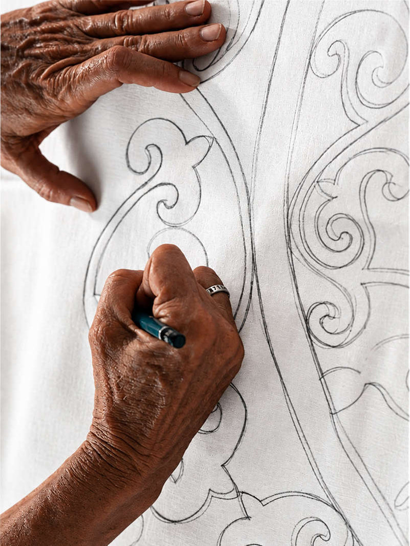 Pencil tip tracing a Zebra line on stretched white silk