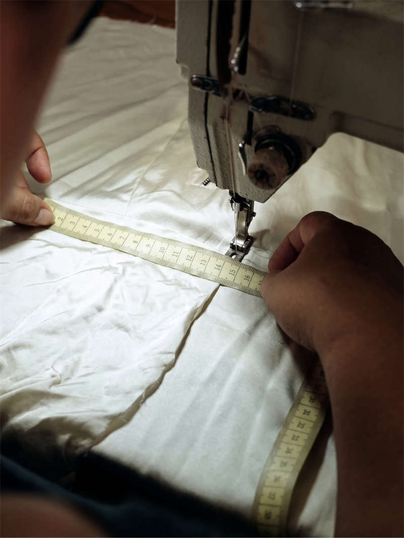 Seamstress finishing a kimono hem