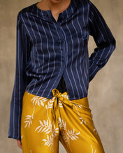 Load image into Gallery viewer, woman short jacket made in silk batik with stripes motif blue and light blue wear on top of a long silk pant yellow gold with withe floral motif
