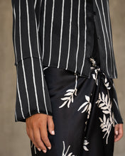 Load image into Gallery viewer, woman wearing short silk jacket black and white on a silk black pant with floral motif
