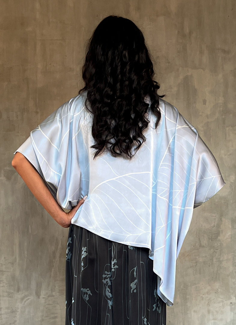 woman silk satin top hand painted in Bali in batik style and dark grey skirt