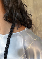 woman silk top detail color light blue with white pattern floreal