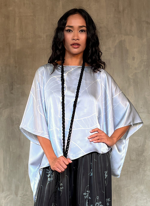 woman silk satin top hand painted in Bali in batik floreal style and dark grey skirt