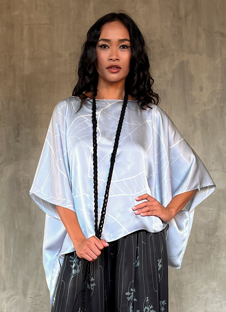 woman silk satin top hand painted in Bali in batik floreal style and dark grey skirt