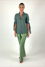 Load and play video in Gallery viewer, Quarzia signature pant has been a popular success since our brand started. Its 3 sizes will fit a wide range of silhouettes.  The knot on the waist allows great adjustment following your body needs. It&#39;s great to wear it in the day and classy for your special evenings.  Paired here with Boss cotton shirt in Olive-night color.    One-size. 100% Satin Silk. Motif: Plain. Color: Oil-green. Available also in: Arona-grey, Black, Fig, Hazel, Medieval-blue, Molten-lava, Olive-night, Orchid-mist.
