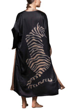 Load image into Gallery viewer, Quarzia signature Kimono has wide, flowing sleeves and it&#39;s handcrafted from pure silk satin. As Japanese style&#39; kimono  it is open under the arms. A bold contrast color border on the cuffs and on the front, together with the same color silk belt, frame this elegant piece, ultimate in relaxed style, elegance and comfort. The batik pattern is inspired by the stillness pose of a tiger.
