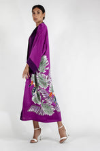 Load image into Gallery viewer, Side detail: Quarzia signature Kimono has wide, flowing sleeves and it&#39;s handcrafted from pure silk satin. As Japanese style&#39; kimono  it is open under the arms. A bold contrast color border on the cuffs and on the front, together with the same color silk belt, frame this elegant piece, ultimate in relaxed style, elegance and comfort. The batik pattern is inspired by the incredible balinese leafy jungle and colorful tucans beauty.
