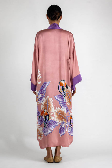 Back detail: Quarzia signature Kimono has wide, flowing sleeves and it's handcrafted from pure silk satin. As Japanese style' kimono  it is open under the arms. A bold contrast color border on the cuffs and on the front, together with the same color silk belt, frame this elegant piece, ultimate in relaxed style, elegance and comfort. The batik pattern is inspired by the incredible balinese leafy jungle and colorful tucans beauty.