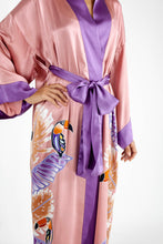 Load image into Gallery viewer, Front detail: Quarzia signature Kimono has wide, flowing sleeves and it&#39;s handcrafted from pure silk satin. As Japanese style&#39; kimono  it is open under the arms. A bold contrast color border on the cuffs and on the front, together with the same color silk belt, frame this elegant piece, ultimate in relaxed style, elegance and comfort. The batik pattern is inspired by the incredible balinese leafy jungle and colorful tucans beauty.
