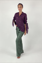 Load and play video in Gallery viewer, Quarzia signature pant has been a popular success since our brand started. Its 3 sizes will fit a wide range of silhouettes.  The knot on the waist allows great adjustment following your body needs. It&#39;s great to wear it in the day and classy for your special evenings.   Paired here with Boss cotton shirt in Fig color.  One-size. 100% Satin Silk. Motif: Plain. Color: Olive-night. Available also in: Arona-grey, Black, Fig, Hazel, Medieval-blue, Molten-lava, Oil-green, Orchid-mist.
